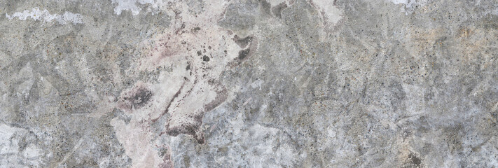 Concrete wall. Weathered old paints on the spilled wall.