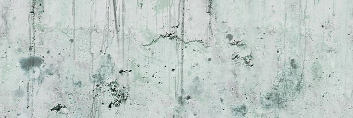 Concrete wall. Weathered old paints on the spilled wall.