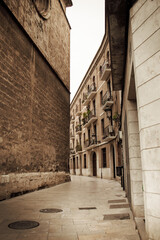 Fototapeta na wymiar Old, stone-walled city streets in Valencia, Spain