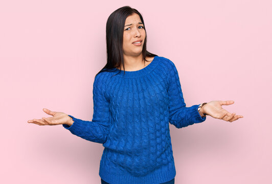 Young hispanic woman wearing casual clothes clueless and confused with open arms, no idea concept.