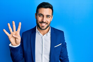 Young hispanic businessman wearing business jacket showing and pointing up with fingers number four...
