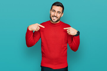 Young hispanic man wearing casual clothes looking confident with smile on face, pointing oneself...
