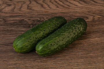 Green fresh cucumbers over background