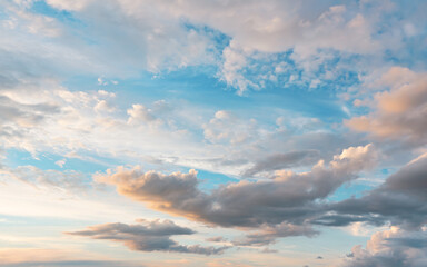 Naklejka na ściany i meble Evening sky with some yellow, white, grey and dark clouds