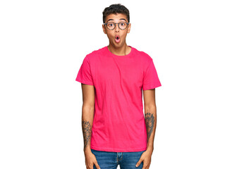 Fototapeta premium Young handsome african american man wearing casual clothes scared and amazed with open mouth for surprise, disbelief face