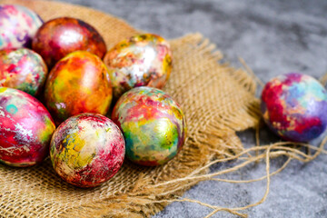Colorful hand painted purple and rose  easter eggs and  spring blossom on wooden background