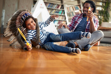 Naklejka premium A Dad and a son playing on the floor at home together. Family, together, love, playtime