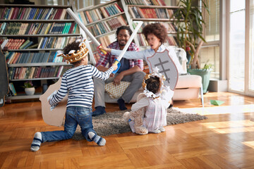 Mom and her son playing with swords and enjoying a playtime with family at home. Family, together, love, playtime - Powered by Adobe