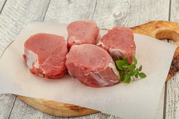Raw pork medallion served rosemary