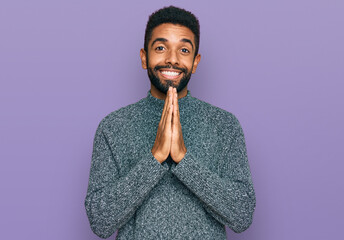 Young african american man wearing casual clothes praying with hands together asking for forgiveness smiling confident.