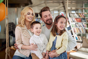 A cheerful family spending a quality time at home together. Family, leisure, together