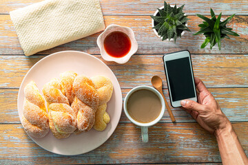 Woman hand using blank smart phone during breakfast