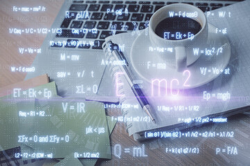 Double exposure of formula drawing and desktop with coffee and items on table background. Concept...
