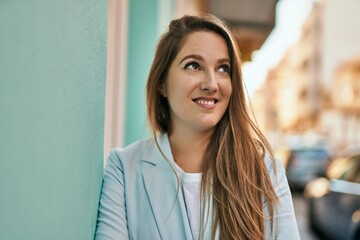 Fototapeta premium Young blonde businesswoman smiling happy standing at the city.