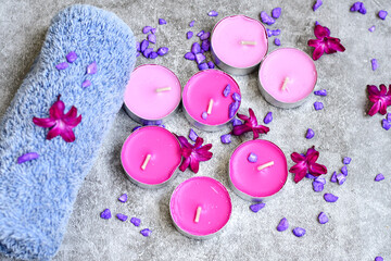 Obraz na płótnie Canvas SPA and wellness setting/ Natural sea salt, candles and lilac flowers. Spa products and accesories for aromatherapy