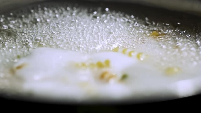 Boiling Pastas in Cooker. Hot Water and Bubbles Close Up Shot. 4K Resolution. 