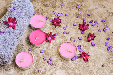 SPA and wellness setting/ Natural sea salt, candles and lilac flowers. Spa products and accesories for aromatherapy