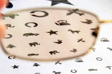 The medicine. Glasses lie on the table for checking vision in children