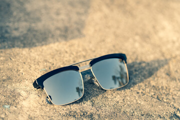 Classic sunglasses model with silver lenses shoot in a summer day closeup . Selective focus. High quality photo