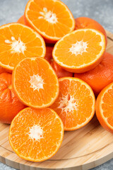 Sliced juicy fresh orange fruits in a wooden plate