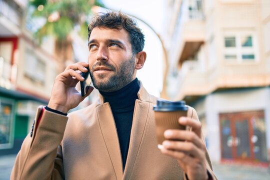 Handsome business man wearing elegant jacket using smartphone smiling happy outdoors
