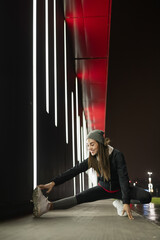 Young woman stretching before her evening training