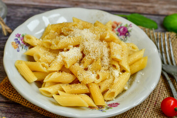  Home made  italian penne rigate pasta  with parmesan cheese,garlic  and black pepper .Pasta cacio e pepe. Mediterranean food concept