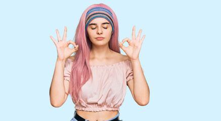 Young hispanic girl with pink hair relax and smiling with eyes closed doing meditation gesture with fingers. yoga concept.