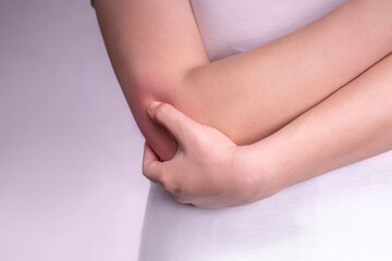 Fototapeta na wymiar the girl holds a bruised reddened elbow