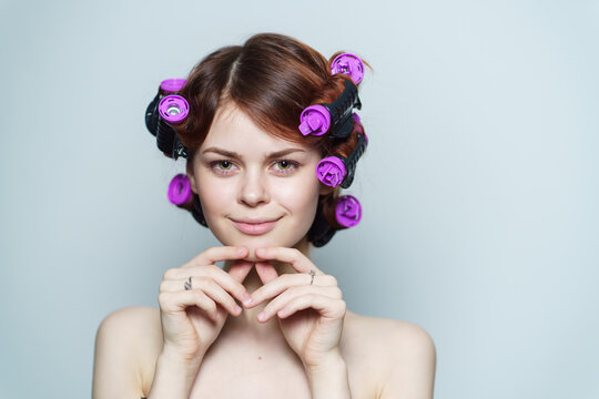 happy woman with curly hair purple curlers hairstyle bare shoulders