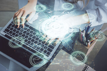 Double exposure of woman hands typing on computer and social network theme hologram drawing. People media concept.