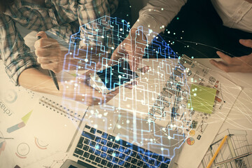 Double exposure of man and woman working together holding and using a mobile device and brain hologram drawing.