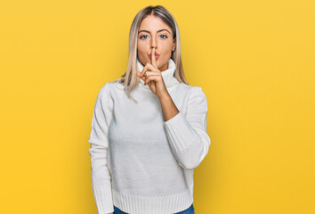Beautiful blonde woman wearing casual turtleneck sweater asking to be quiet with finger on lips. silence and secret concept. - obrazy, fototapety, plakaty