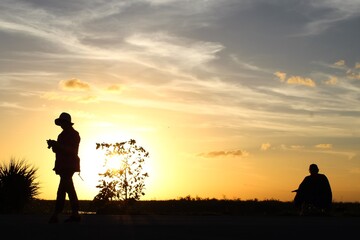 Fototapeta na wymiar Silhouettes of people in the sunset swamp