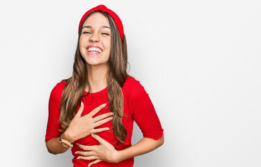 Young brunette woman wearing casual clothes smiling and laughing hard out loud because funny crazy...