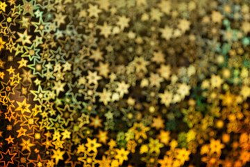 Gold stars shimmer in different shades, starry bokeh, background