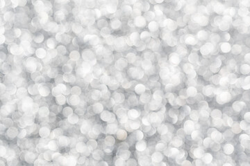Silver bokeh. The effect of and blurring shiny balls. Defocused holiday lights. Glitter