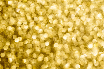 Gold bokeh. The effect of and blurring shiny balls. Defocused holiday lights. Glitter