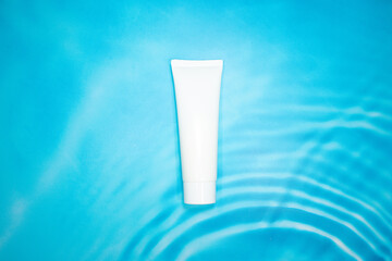 white cosmetic container on blue background
