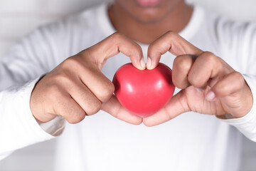  hand holding red heart symbol on white background 