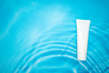 white cosmetic container on blue background