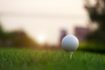 golf ball on tee in a beautiful golf course with morning sunshine