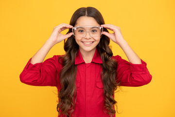 happy kid girl in safety glasses for eye protection, vision