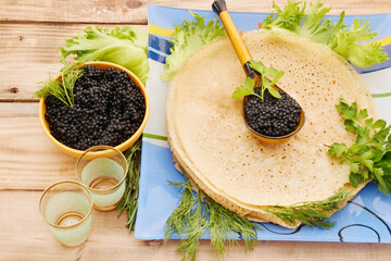 Pancakes with black caviar