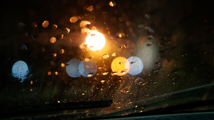 Drops of night rain on the windshield of the car, next to the wipers. The concept of depression,...