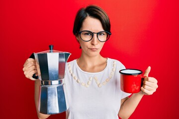 Young brunette woman with short hair drinking italian coffee skeptic and nervous, frowning upset because of problem. negative person.