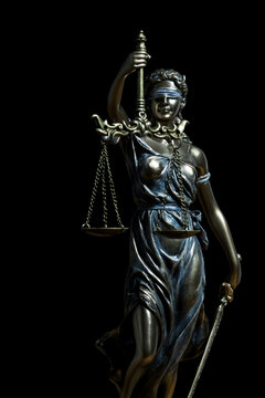 Close-up Of Justice Lady Against Black Background. Statue of justice. vertical image isolated on black background
