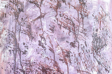 Obraz premium Chaotic splashes of paint on a wooden surface as a background.