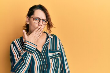 Young caucasian woman wearing casual clothes and glasses bored yawning tired covering mouth with...