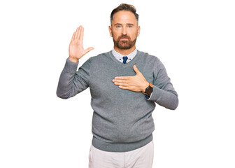 Handsome middle age man wearing business clothes swearing with hand on chest and open palm, making a loyalty promise oath